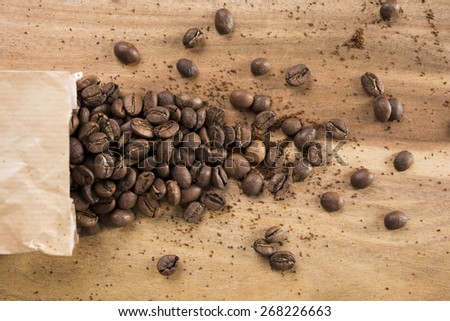 coffee beans and ground coffee with paper bag on table