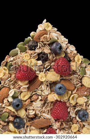 studio shoot of flakes, cereal, almond, dry fruit, seeds, fresh fruit on black background