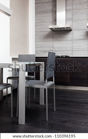 Fragment of modern minimalism style kitchen with dining table