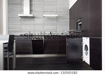 Part of black hardwood kitchen with build-in domestic technique