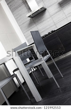 Fragment of modern minimalism style kitchen with dining table