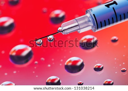 Syringe needle with fluid drops on droplets water background, macro view