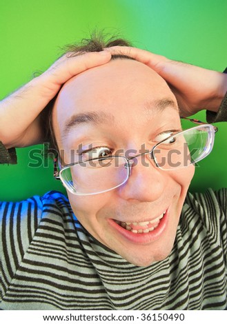 Funny surprised man in glasses portrait on vivid color background
