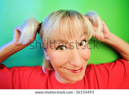 Funny cunning woman portrait on vivid color background