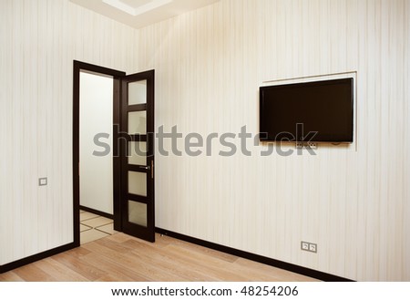 Empty drawing room interior with door and TV