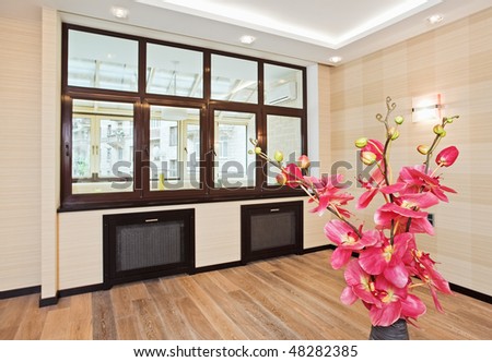 Empty living room interior in modern style with orchid flowers in wicker withe vase