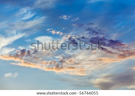 Cumulus clouds on sunset sky background