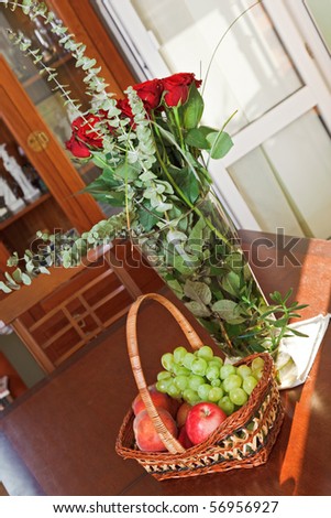 Composition with fruits basket and flowers in a vase