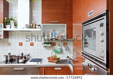 Part of Kitchen interior with wooden furniture and build in microwave oven