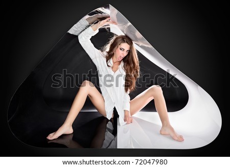 Young aggressive sexy lady with long hairs in abstract plastic tube, ring flash fashion portrait