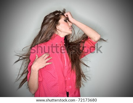 Sorrowful brunette woman dressed in pink blouse with long hairs, ring flash studio portrait on white