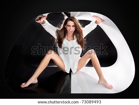 Young aggressive sexy lady with long hairs in abstract plastic tube, ring flash fashion portrait