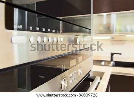 Build in microwave oven in modern kitchen interior with hardwood furniture