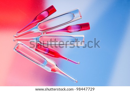 Medical ampoules on red and blue vivid color background