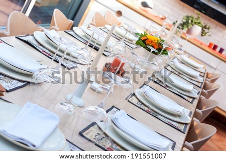 festive table with wine-glasses, gold rim dishes and decoration