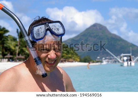 Man with mask and snorkel is snorkeling at mauritius