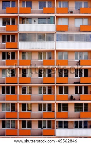 Orange Facade with balcony of panel house
