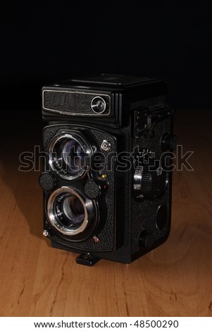 Old camera for middle format film on wooden table