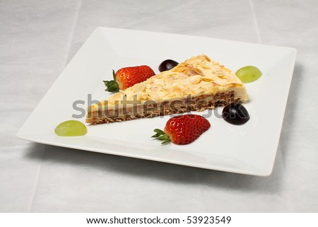 Piece of apple pie with strawberry and vine