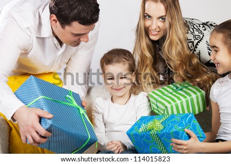 Happy family with presents. Father and mother give presents to they daughter