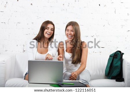 Casual dressed high school student girl study using laptop