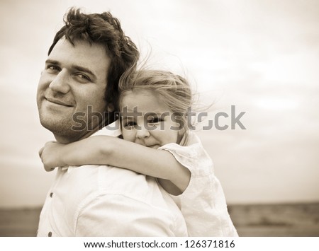 Happy Young Father With Little Daughter Outdoors