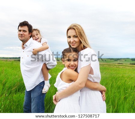 Happy young family with two children outdoors