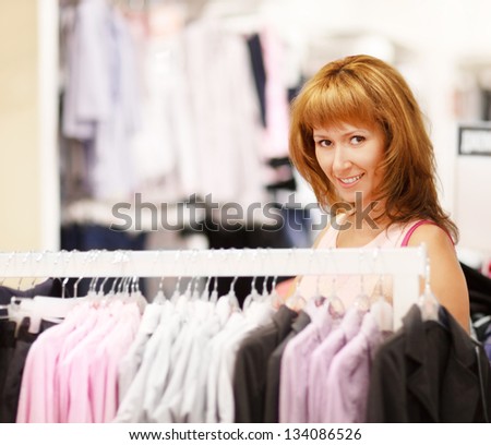 Happy young woman shopping in clothing store