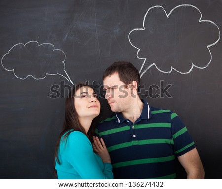 Young happy couple thinking. Chalk drawing on dark background