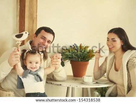 Happy Smiling Family With One Year Old Baby Girl Drinking Coffee Indoor