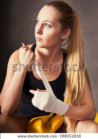 Portrait of a woman boxer wearing white strap on wrist
