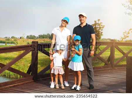 Portrait of a happy young family in golf country club