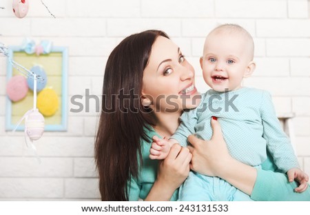 Happy mother and baby spending time together. Easter time