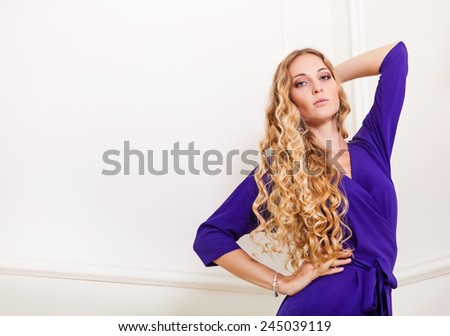 Portrait of the beautiful blond woman in long violet dress