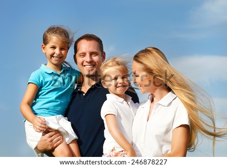 Happy young family with two children outdoors. Summertime