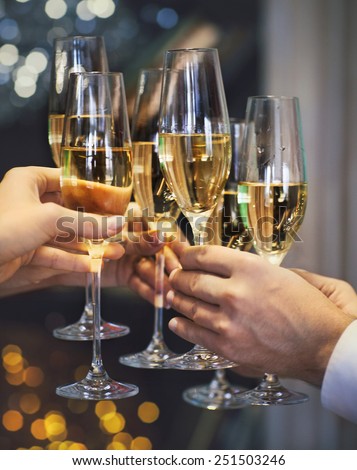 Celebration. People holding glasses of champagne making a toast. DOF. Natural light. Photo in motion. Toned image