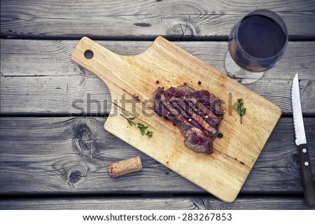 BBQ steak. Barbecue grilled beef steak meat with red wine and knife. Healthy food. Barbeque steak dinner