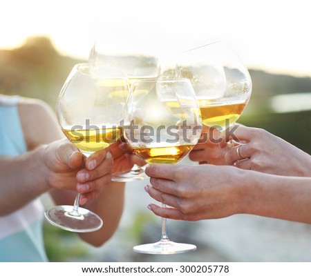 Celebration. People holding glasses of red wine making a toast