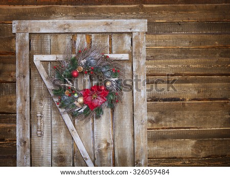 Christmas wreath on a rustic wooden front door