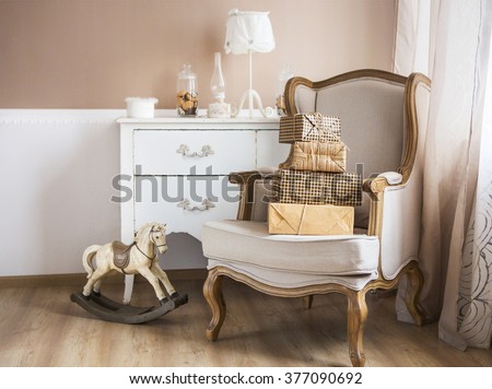 Part of a parenting and baby room with armchair and dresser