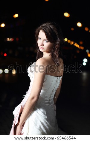 stock photo Beautiful bride in wedding dress in the night city