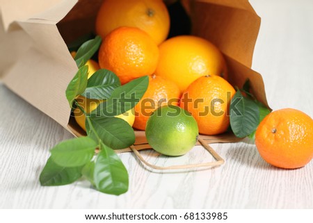 Fresh citrus fruits in the package on a wooden table