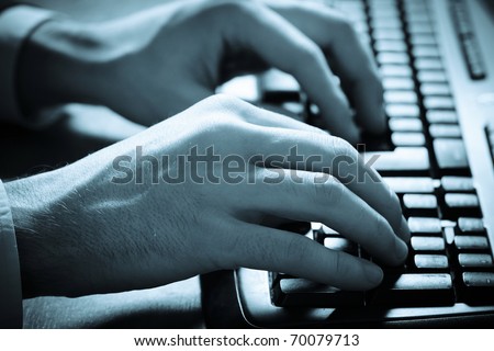 Business man typing on a computer keyboard. Close up