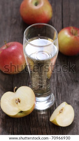 Apple cider and apples on rustic wooden table