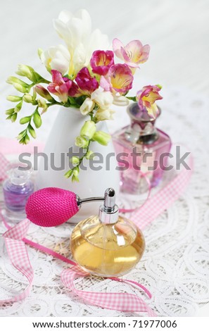 Vintage perfume bottles and flowers on the table