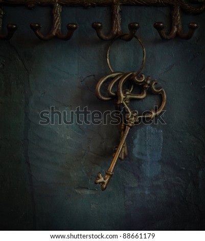 Ring of vintage skeleton keys over old rustic wall