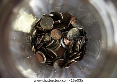 looking down at change in a jar