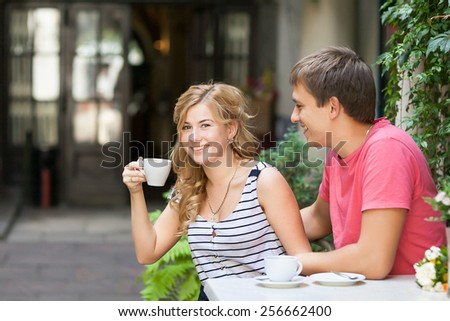 Happy couple having a great time talking over a cup of coffee