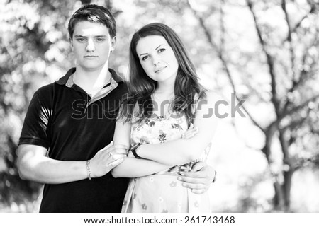 an image of summer holidays and dating concept - smiling couple watching on photographer