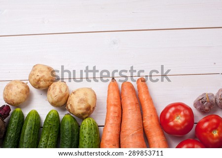 potato, tomato, garlic, cucumber,beet on wooden table. top view.
